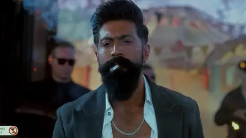 Still 4 of Toxic (2026) V2 HQ-HDTC [Hindi-Kannada-Tamil-Telugu] (LiNE) 1080p 720p & 480p Multi Audio [x264/HEVC]