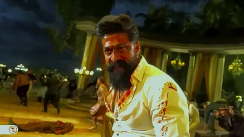 Still 7 of Toxic (2026) V2 HQ-HDTC [Hindi-Kannada-Tamil-Telugu] (LiNE) 1080p 720p & 480p Multi Audio [x264/HEVC]